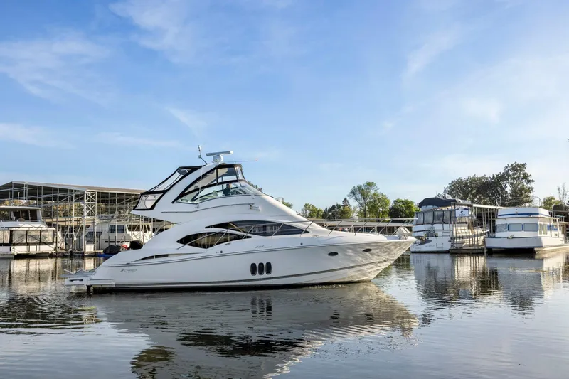 Slide: The Image of 2008 Cruisers Yachts 447 Sport Sedan docked at a marina under clear blue skies. - 56