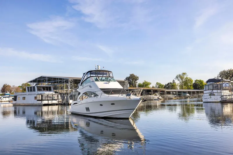 Slide: The Image of 2008 Cruisers Yachts 447 Sport Sedan docked in a serene marina setting. - 57