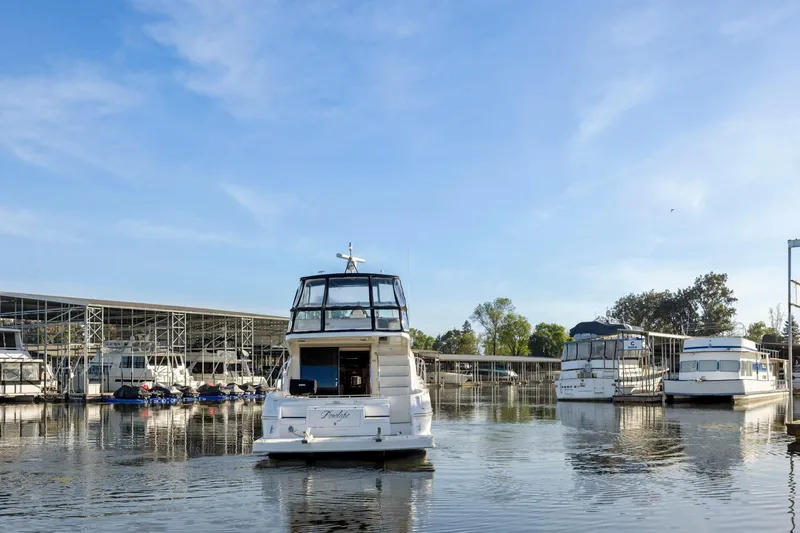 Slide: The Image of 2008 Cruisers Yachts 447 Sport Sedan docked at marina under clear blue sky. - 59