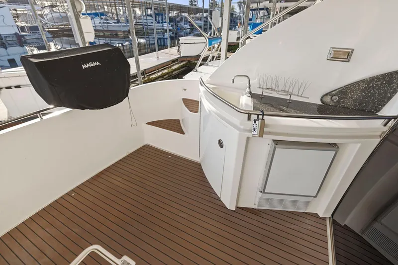 Slide: The Image of 2008 Cruisers Yachts 447 Sport Sedan deck with sink and grill, docked at marina. - 6