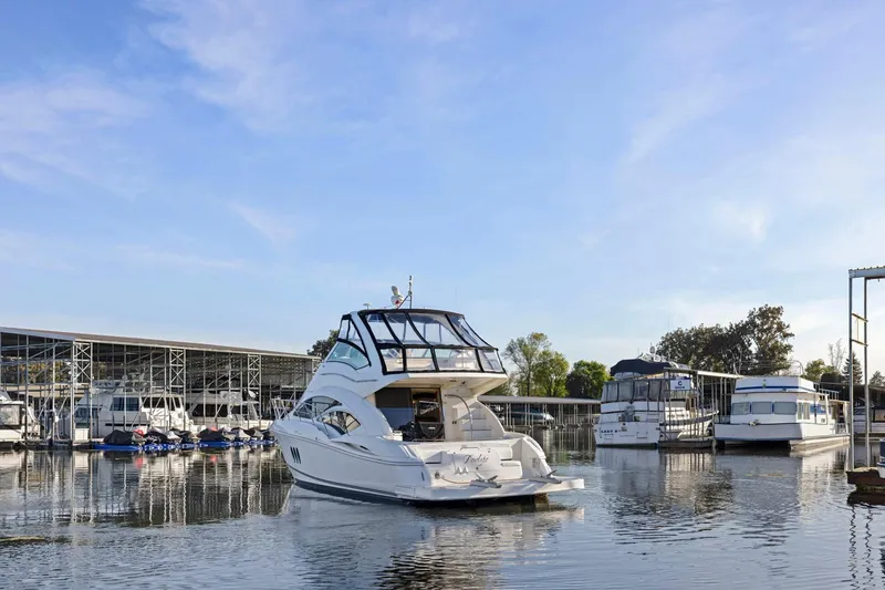 Slide: The Image of 2008 Cruisers Yachts 447 Sport Sedan docked at a marina under a clear blue sky. - 60