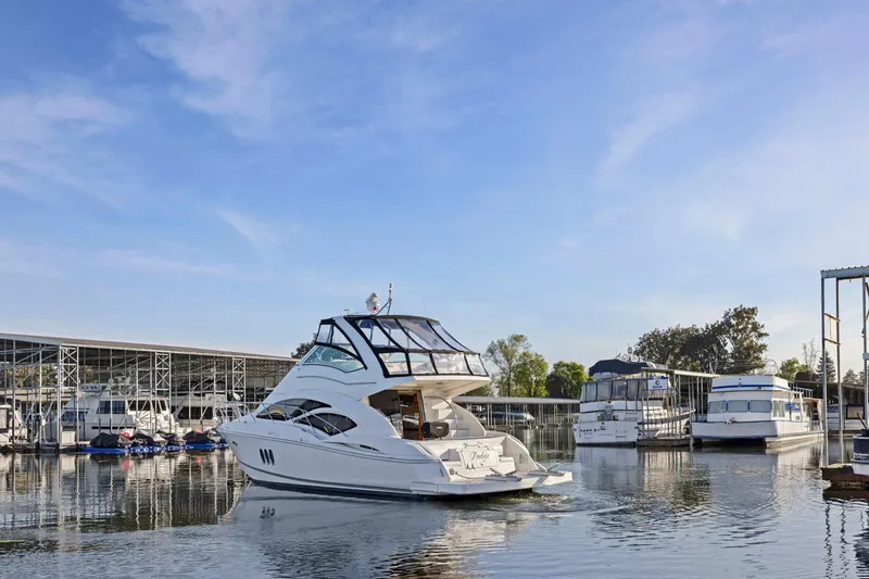 Slide: The Image of 2008 Cruisers Yachts 447 Sport Sedan in marina, clear sky, calm water. - 61