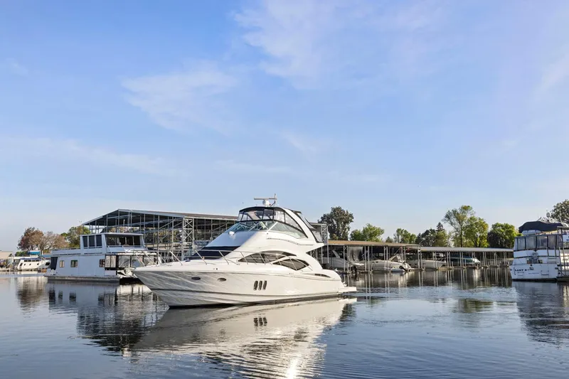 Slide: The Image of 2008 Cruisers Yachts 447 Sport Sedan on calm water near marina. - 66