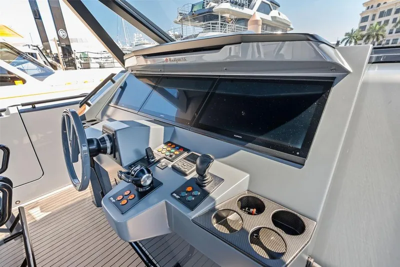 Slide: The Image of Helm of 2024 Vanquish Yachts VQ55 with modern controls and navigation screens. - 13