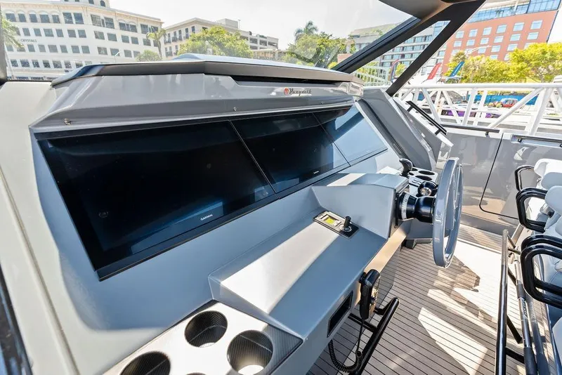 Slide: The Image of 2024 Vanquish Yachts VQ55 helm with modern controls and sleek design. - 14