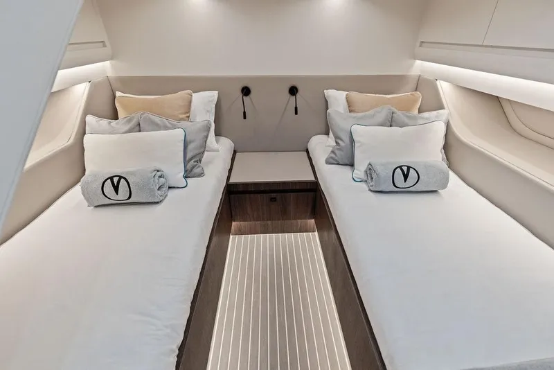 Slide: The Image of Luxurious 2024 Vanquish Yachts VQ55 cabin interior with twin beds and elegant decor. - 23