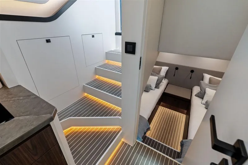 Slide: The Image of Luxurious interior of 2024 Vanquish Yachts VQ55 with modern lighting and twin beds. - 28