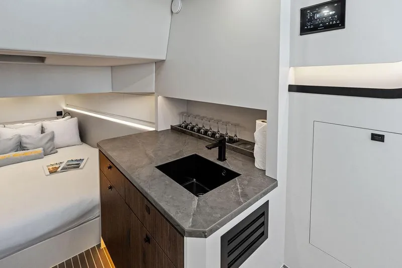 Slide: The Image of Luxurious interior of 2024 Vanquish Yachts VQ55 featuring modern kitchenette and cozy sleeping area. - 34