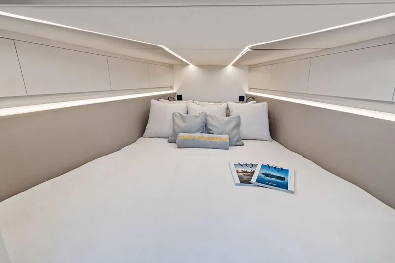 Slide: The Image of Luxurious interior cabin of 2024 Vanquish Yachts VQ55 with modern bedding and magazines. - 37