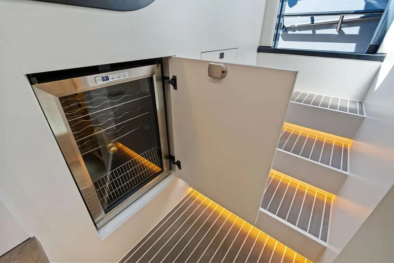Slide: The Image of Luxury yacht interior with illuminated stairs and built-in wine cooler, Vanquish Yachts VQ55 2024. - 39