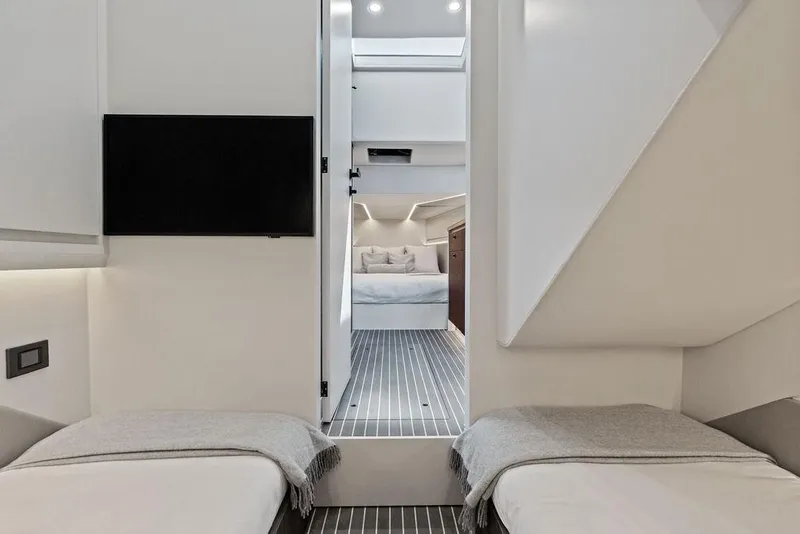 Slide: The Image of Luxurious interior of 2024 Vanquish Yachts VQ55 with modern twin beds and sleek design. - 42