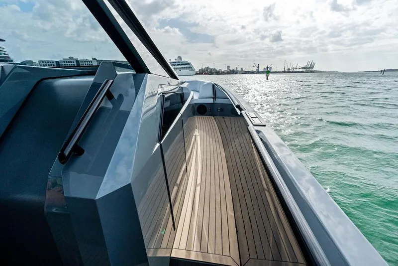 Slide: The Image of 2024 Vanquish Yachts VQ55 luxury yacht deck with sleek design on open water. - 46