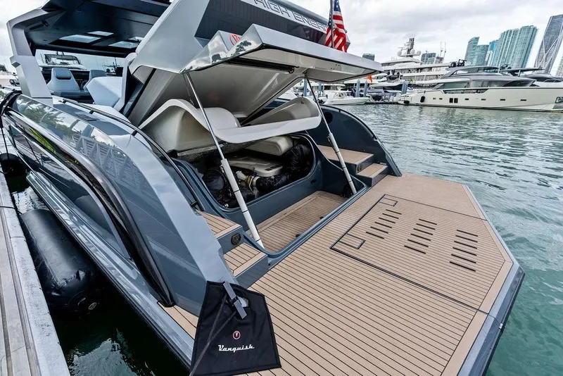 Slide: The Image of 2024 Vanquish Yachts VQ55 luxury yacht docked, showcasing sleek design and spacious deck. - 49