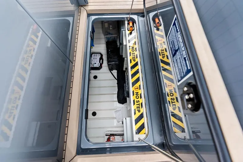 Slide: The Image of Engine compartment of 2024 Vanquish Yachts VQ55 with "No Step" warning labels. - 50