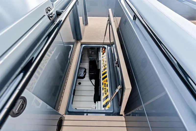 Slide: The Image of 2024 Vanquish Yachts VQ55 storage compartment with "No Step" warning label. - 51