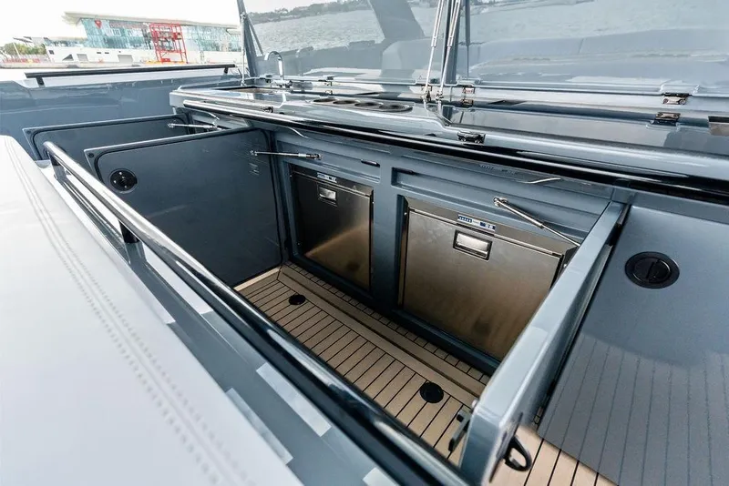 Slide: The Image of 2024 Vanquish Yachts VQ55 yacht interior with open storage compartments and sleek design. - 53