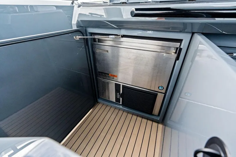 Slide: The Image of 2024 Vanquish Yachts VQ55 interior with stainless steel refrigerator and sleek design. - 54