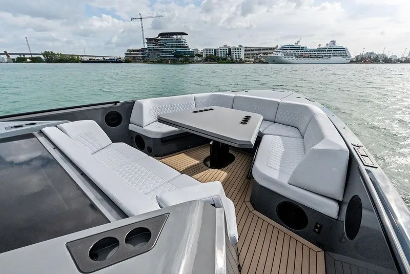 Slide: The Image of Luxurious 2024 Vanquish Yachts VQ55 with elegant seating and scenic waterfront view. - 56