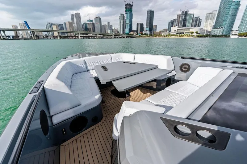 Slide: The Image of Luxurious 2024 Vanquish Yachts VQ55 with elegant seating, city skyline in background. - 60