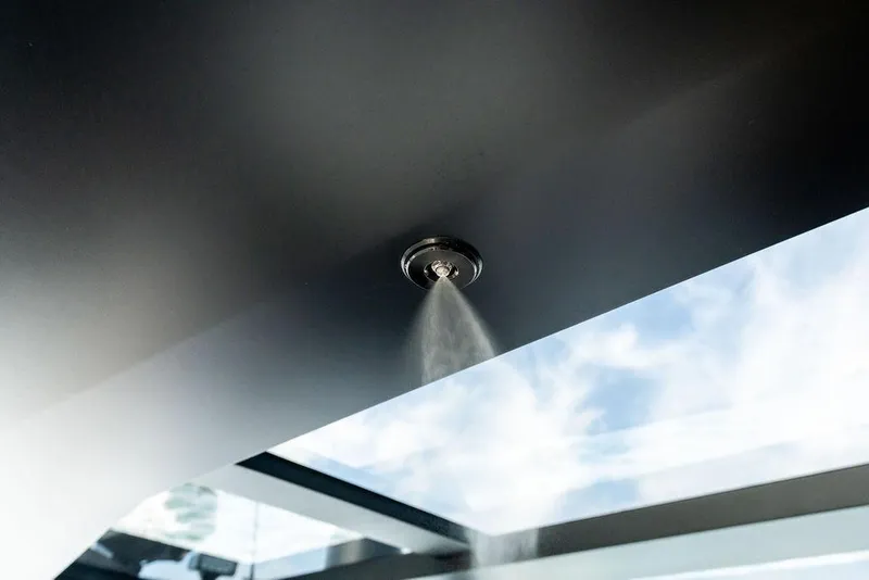 Slide: The Image of Ceiling-mounted misting system on 2024 Vanquish Yachts VQ55, with sky view. - 63