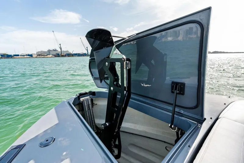 Slide: The Image of 2024 Vanquish Yachts VQ55 yacht with open hatch, showcasing sleek design on the water. - 66