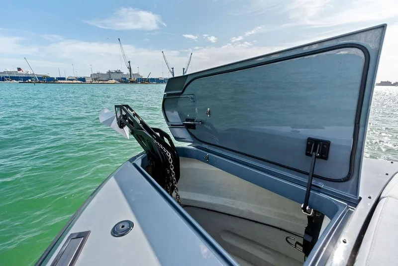 Slide: The Image of 2024 Vanquish Yachts VQ55 anchor compartment open on calm water. - 67