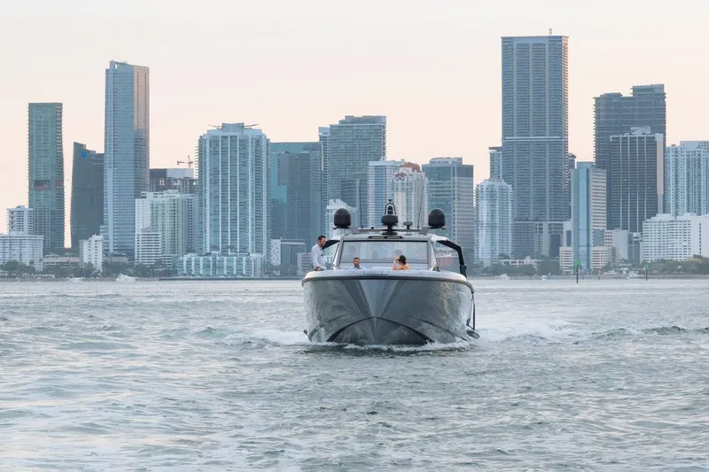 Slide: The Image of 2024 Vanquish Yachts VQ 55 cruising with city skyline backdrop. - 7