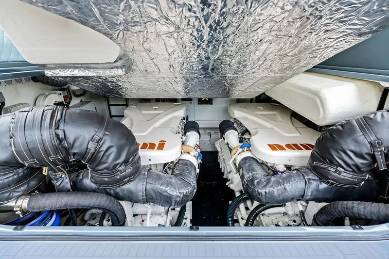 Slide: The Image of Engine compartment of 2024 Vanquish Yachts VQ55, showcasing dual engines and insulated components. - 70