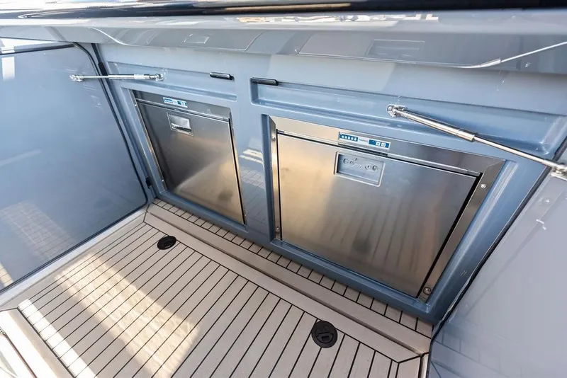 Slide: The Image of 2024 Vanquish Yachts VQ55 yacht interior with stainless steel appliances and sleek design. - 9