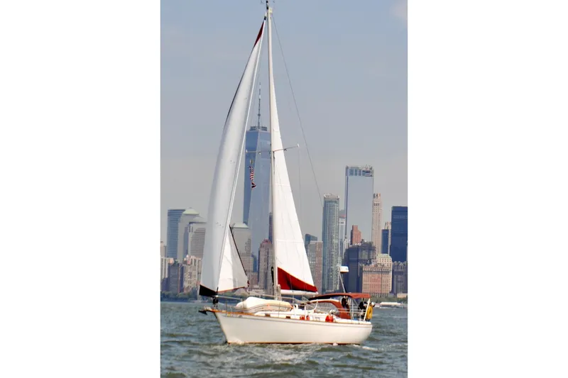 Slide: The Image of 1980 Pearson 365 Sloop sailing on open water under clear skies. - 20