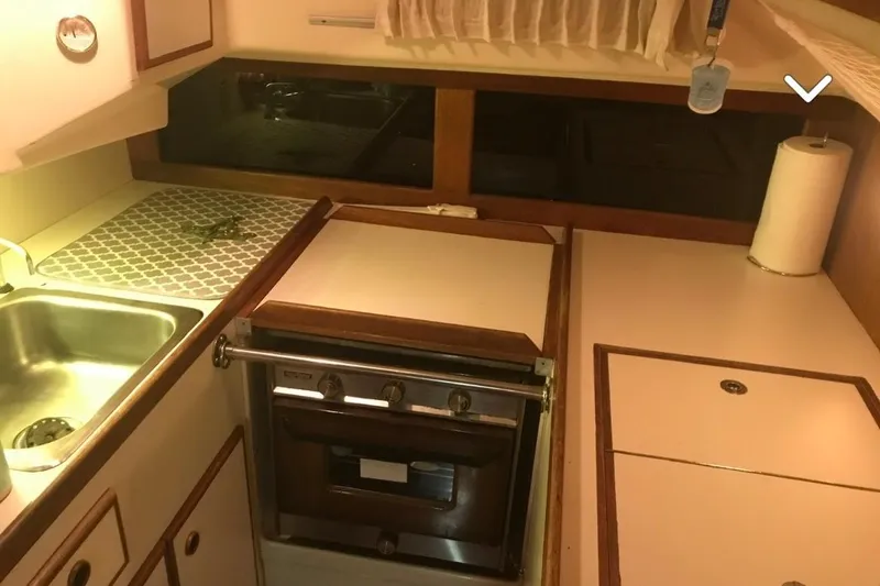Slide: The Image of 1980 Pearson 365 Sloop kitchen with stove, sink, and countertop. - 22