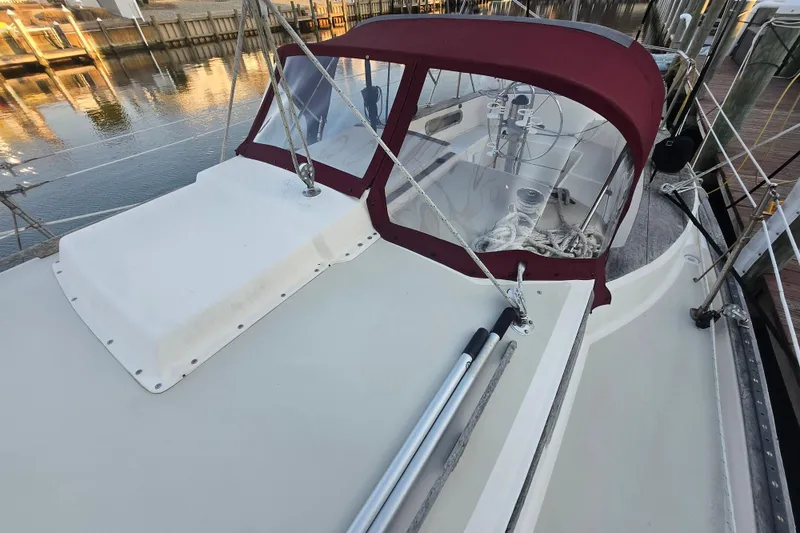 Slide: The Image of 1980 Pearson 365 Sloop sailboat with maroon canopy docked at marina. - 27