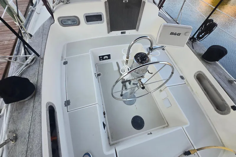 Slide: The Image of Cockpit of a 1980 Pearson 365 Sloop with steering wheel and navigation equipment. - 30