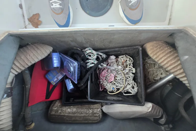 Slide: The Image of Storage compartment of a 1980 Pearson 365 Sloop with ropes and supplies. - 36
