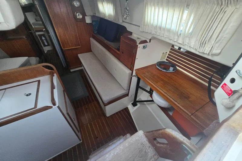 Slide: The Image of Interior of 1980 Pearson 365 Sloop, featuring wooden cabinetry and seating area. - 37