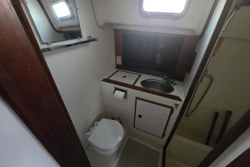 Slide: The Image of 1980 Pearson 365 Sloop bathroom with sink, toilet, and shower area. - 47