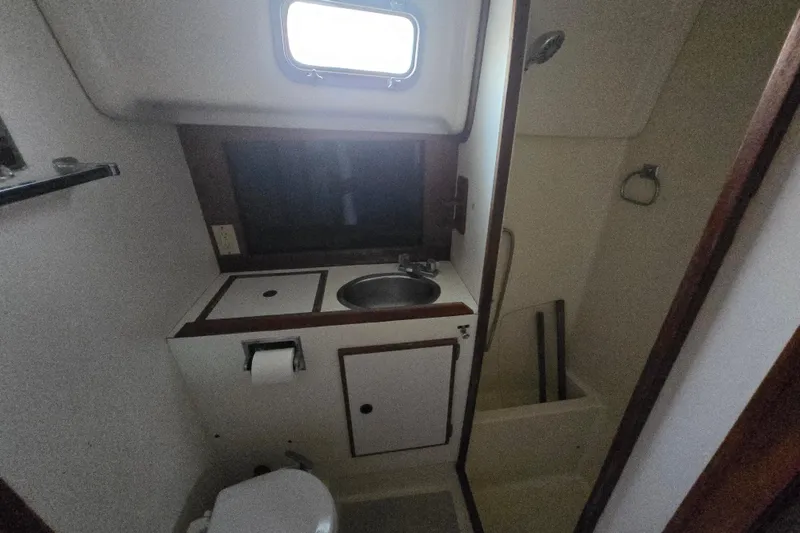 Slide: The Image of 1980 Pearson 365 Sloop bathroom with sink, toilet, and window. - 48