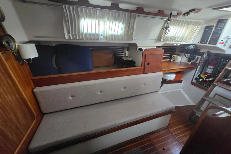 Slide: The Image of Interior of 1980 Pearson 365 Sloop with wooden furnishings and cozy seating area. - 49