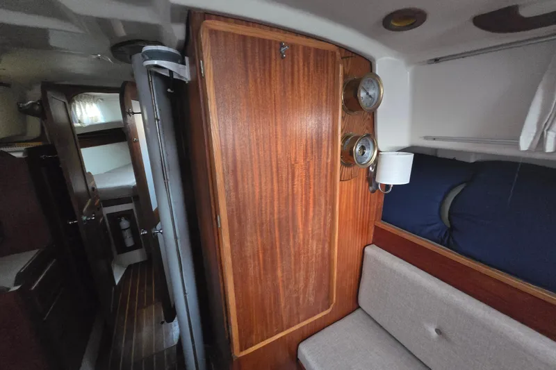 Slide: The Image of Interior of 1980 Pearson 365 Sloop sailboat with wooden cabinetry and cozy seating area. - 50
