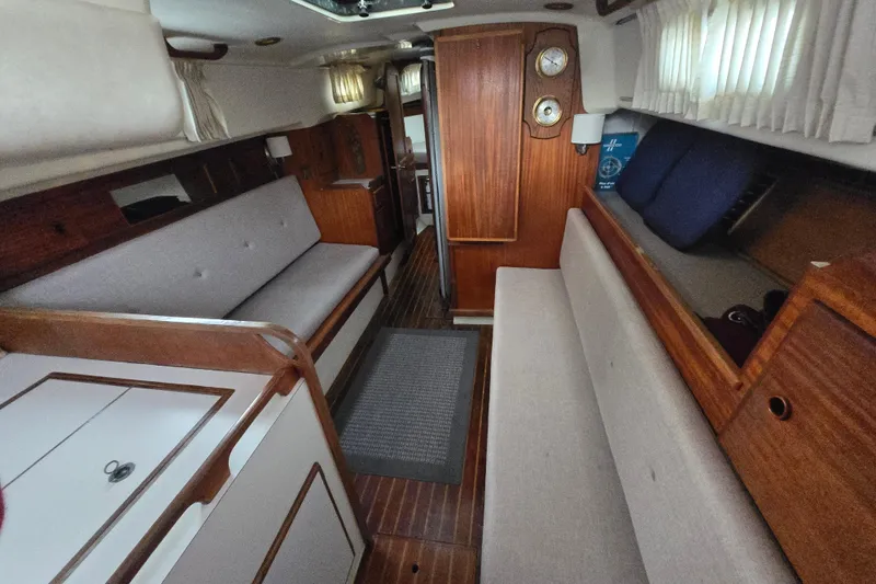 Slide: The Image of Interior of a 1980 Pearson 365 Sloop sailboat with wooden finishes and cozy seating. - 52