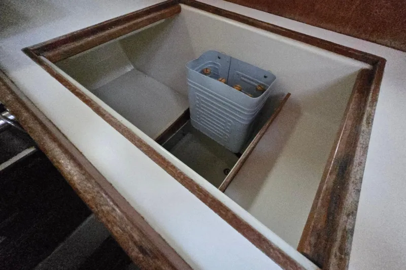 Slide: The Image of Interior storage compartment of 1980 Pearson 365 Sloop sailboat with a plastic container. - 53