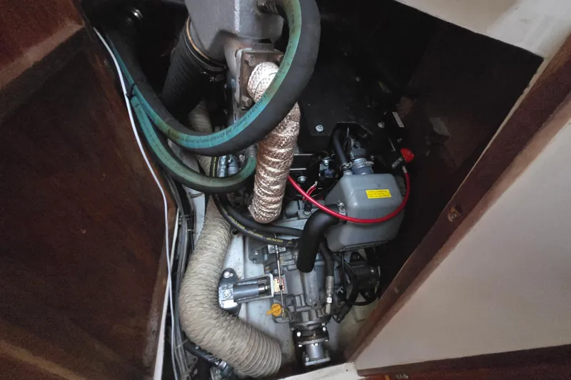 Slide: The Image of Engine compartment of a 1980 Pearson 365 Sloop sailboat, showing hoses and mechanical components. - 59