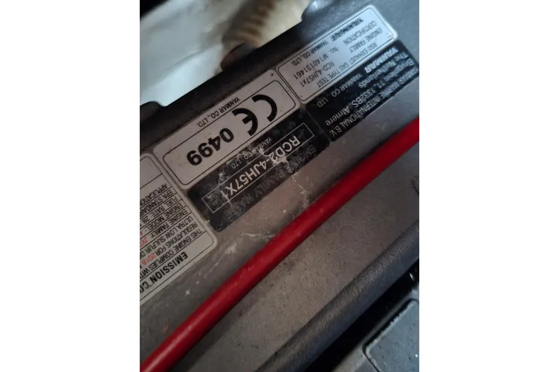 Slide: The Image of Close-up of a Pearson 365 Sloop 1980 engine label with red cable. - 61