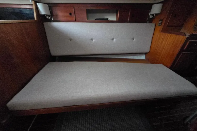 Slide: The Image of Interior of 1980 Pearson 365 Sloop with cushioned seating and wooden cabinetry. - 64