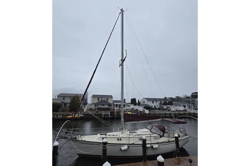 Slide: The Image of 1980 Pearson 365 Sloop sailing at sunset on calm waters. - 7