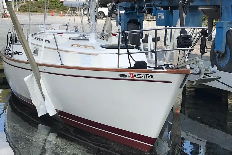 Slide: The Image of 1980 Pearson 365 Sloop docked in a marina, showcasing its classic design and rigging. - 12