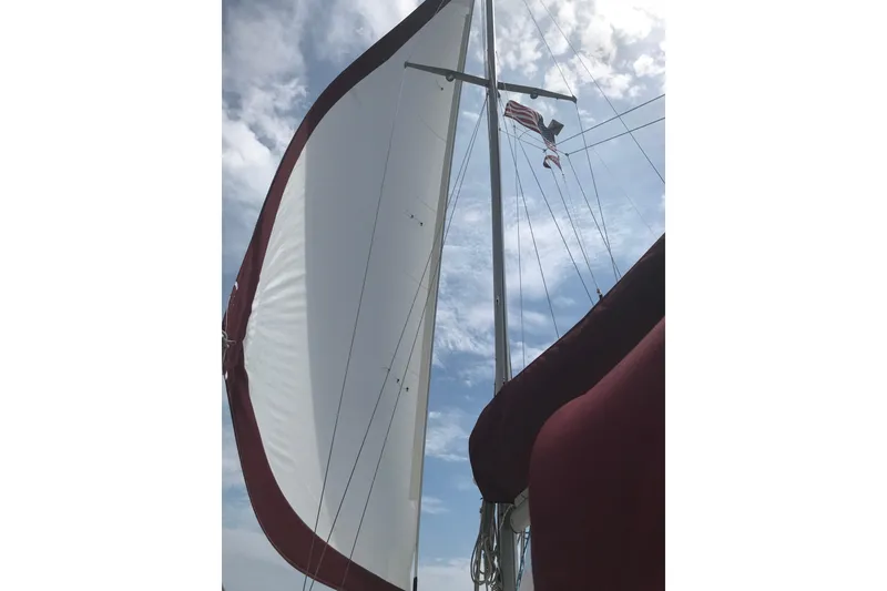 Slide: The Image of 1980 Pearson 365 Sloop sailboat docked in a residential marina setting. - 13