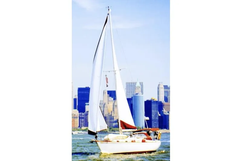 Slide: The Image of Bow of 1980 Pearson 365 Sloop with anchor and railing, docked by the water. - 14