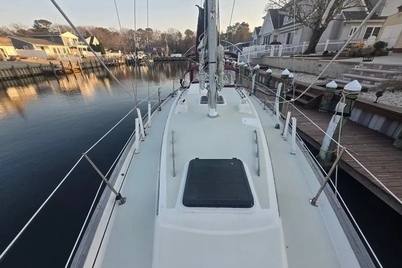 Slide: The Image of 1980 Pearson 365 Sloop docked in a serene marina setting. - 25