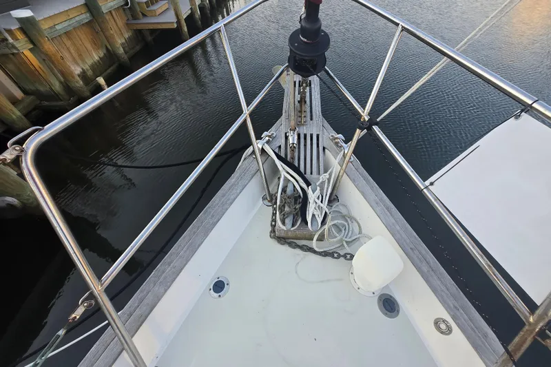 Slide: The Image of Bow of 1980 Pearson 365 Sloop with anchor and ropes, docked at marina. - 26
